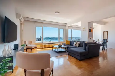 a living room with a couch and a tv at Bosphorus View with 5 Bedrooms and Elevator in Istanbul