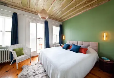 a bedroom with a large bed with blue and red pillows at 3 Bedroom, 2 Bathroom Fully Equipped House in Istanbul