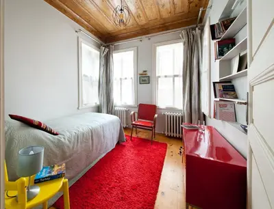 a bedroom with a bed and a red rug at 3 Bedroom, 2 Bathroom Fully Equipped House in Istanbul