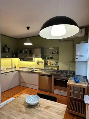 a kitchen with white cabinets and a large light fixture at 3 Bedroom, 2 Bathroom Fully Equipped House in Istanbul