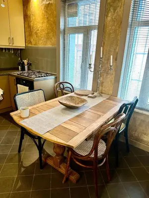 a kitchen with a wooden table and chairs in it at Balat Istanbul Three-Story Restored Ottoman House in Istanbul