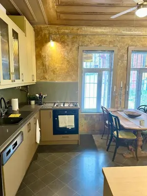 a kitchen with a table and a stove top oven at Balat Istanbul Three-Story Restored Ottoman House in Istanbul