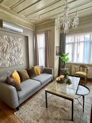 a living room with a couch and a table at Balat Istanbul Three-Story Restored Ottoman House in Istanbul