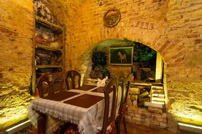 a dining room with a table and chairs in a stone building at Hotel Gedikpasa Family in Istanbul