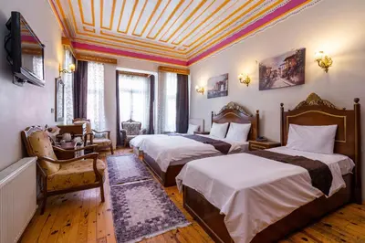 a bedroom with two beds and a coffered ceiling at Hotel Gedikpasa Family in Istanbul