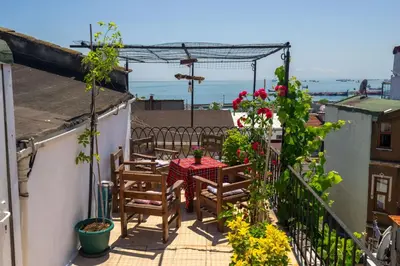 a patio with a table and chairs on a balcony at Hotel Gedikpasa Family in Istanbul