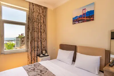 a bedroom with a bed and a window at Hotel Gedikpasa Family in Istanbul