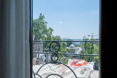 a view from a window of a balcony with an umbrella at Spacious One Bedroom Apartment with View and Elevator in Istanbul