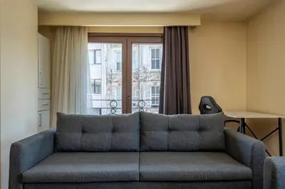 a living room with a couch and a window at Spacious One Bedroom Apartment with View and Elevator in Istanbul