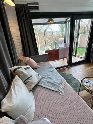 a bedroom with a bed with pillows and a large window at Ağva Nehir Kenarı TinyHouse Jakuzili in Sile