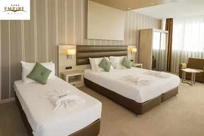 a hotel room with two beds with white sheets at Empire Hotel İstanbul in Istanbul