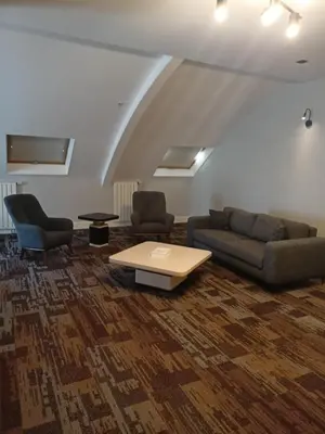 a living room with a couch and two chairs and a table at Empire Hotel İstanbul in Istanbul