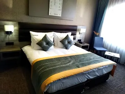 a hotel room with a large bed with pillows at Empire Hotel İstanbul in Istanbul