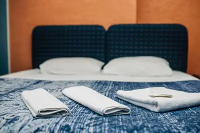 two white towels sitting on top of a bed at Ekinoks Hotel in İznik
