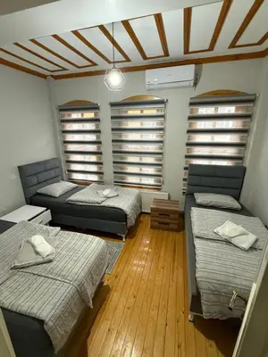 a room with two beds and two windows at Taksim Of The City in Istanbul