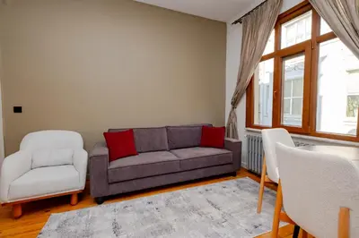 a living room with a couch and a chair at Private Building Featuring Two Separate Apartments in Istanbul
