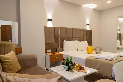 a hotel room with a bed and a table with drinks at Mall Off Palace in Istanbul