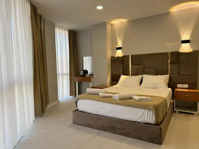a bedroom with a large bed with two towels on it at Mall Off Palace in Istanbul