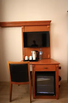 a wooden desk with a microwave and a television at New House Hotel in Istanbul
