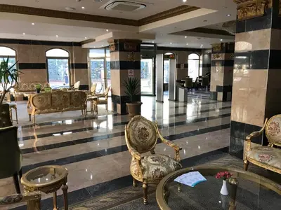 a lobby with chairs and a table in a building at Alrazi Hotel in Istanbul