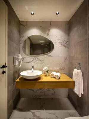 a bathroom with a sink and a mirror at Taksim Juno Residences in Istanbul