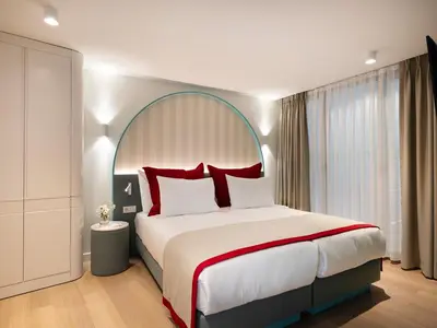 a bedroom with a large bed with red pillows at Taksim Juno Residences in Istanbul