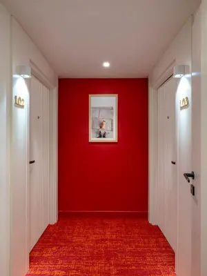a red hallway with a red wall and a picture at Taksim Juno Residences in Istanbul