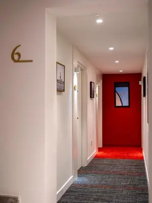 a hallway with a red door and a red carpet at Taksim Juno Residences in Istanbul