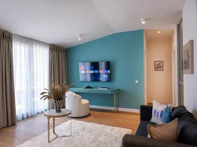 a living room with a blue wall at Taksim Juno Residences in Istanbul