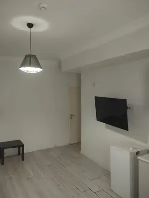 a living room with a flat screen tv on a wall at Şişli Suites - Room 24 in Istanbul
