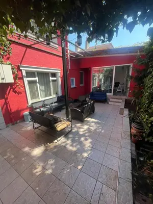 a patio with couches and a red building at Şişli Suites - Room 24 in Istanbul