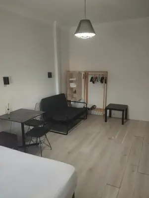 a living room with a black couch and a table at Şişli Suites - Room 24 in Istanbul