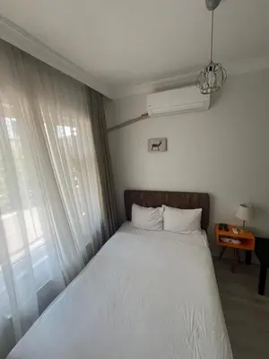 a bedroom with a bed with white sheets and a window at Şişli Suites - Room33 in Istanbul