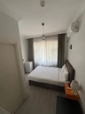 a bedroom with a white bed and a window at Şişli Suites - Room33 in Istanbul