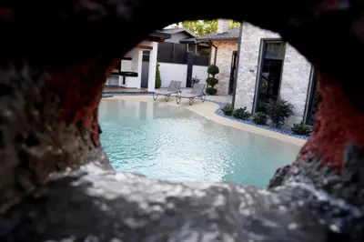 a view of a swimming pool seen through a window at maura beach villas family in Kartepe