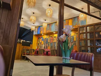 a dining room with a table with flowers on it at MorAgop Suites in Istanbul