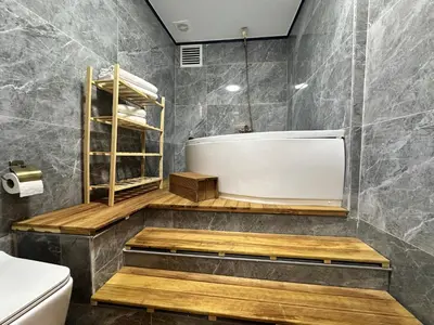 a bathroom with a bath tub and a toilet at MorAgop Suites in Istanbul