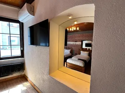 a mirror in a room with a bed and a bedroom at MorAgop Suites in Istanbul