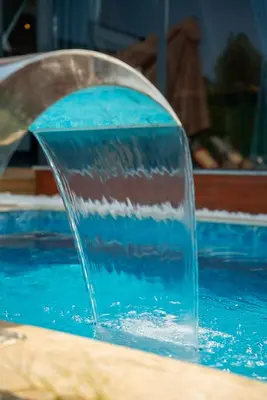 a water fountain in a swimming pool at Armoni Life Bungalov in Yanık