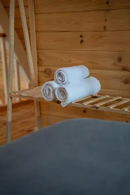 a pile of towels sitting on a shelf at Armoni Life Bungalov in Yanık