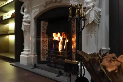 a fireplace in a living room with a fire in it at Arbor Hotel - Signature Collection in Istanbul