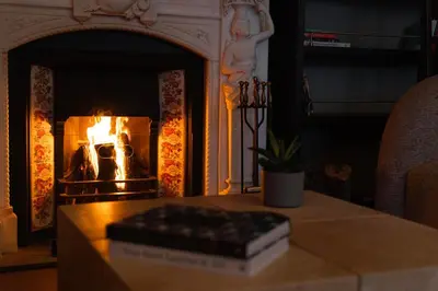 a book sitting on a table in front of a fireplace at Arbor Hotel - Signature Collection in Istanbul