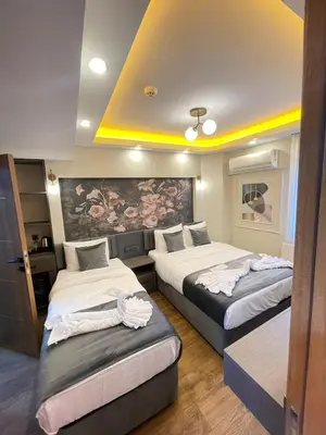 a hotel room with two beds with towels on them at City Hotel İstanbul in Istanbul