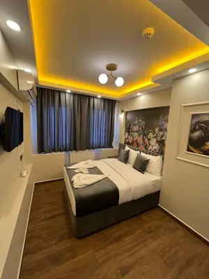 a bedroom with a large bed with a painting on the wall at City Hotel İstanbul in Istanbul