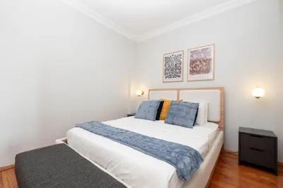 a bedroom with a large white bed with blue pillows at Bosphorus View - Central Location - 3 Bedrooms in Istanbul