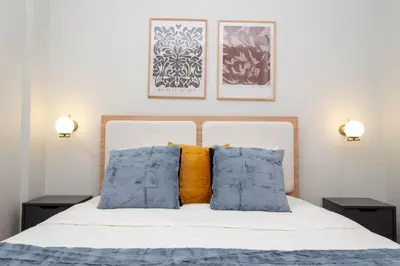 a bedroom with a bed with blue and orange pillows at Bosphorus View - Central Location - 3 Bedrooms in Istanbul