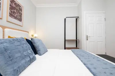 a bedroom with a large white bed with blue pillows at Bosphorus View - Central Location - 3 Bedrooms in Istanbul