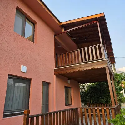 a balcony on the side of a house at Uludağ Tatil Evleri & Villa Şirin in Soğukpınar