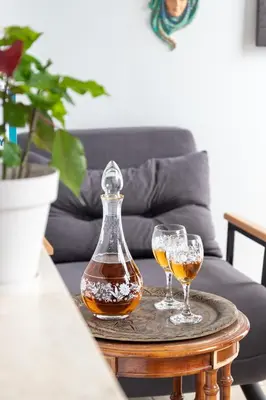 two wine glasses and a decanter on a table at Galley Hotel in Istanbul