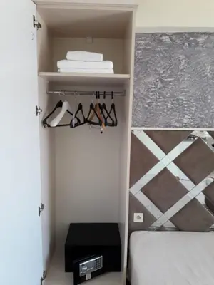 a bedroom with a bed and a shelf with glasses at Terra Suites in Istanbul